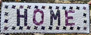 Mini quilt that says "HOME"