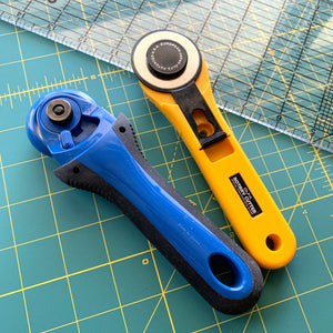 Rotary Cutter Tips - Rotary cutters laying on a self healing mat with ruler