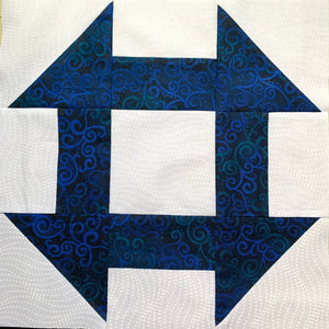 Churn Dash Quilt Block - made with dark blue and white fabric prints