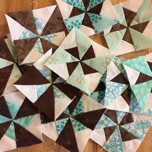 Pile of tiny pinwheel blocks in White, Teal and Brown