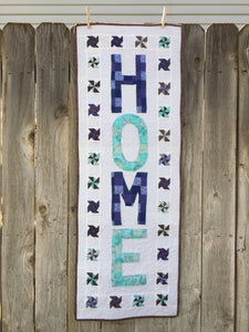 Love at Home Wall Hanging or Table Runner hanging on a wooden fence