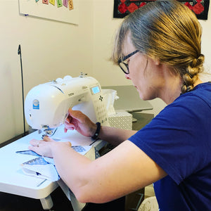 Becky sitting at her sewing machine