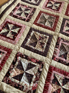 Finished Pin Wheel Quilt in brown, pink, and tan