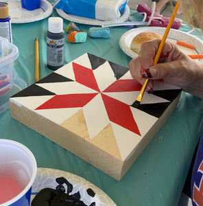 Making a Barn Quilt of Painted Quilt Block - hand painting a red, black and white quilt pattern on a wooden block