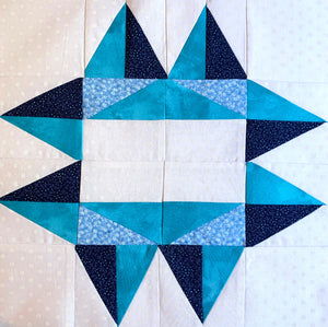 Utah Star Quilt Block with 8 points in blue, teal, and white.