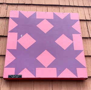 Pink and Purple Barn Quilt on the side of a building