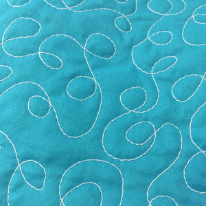 Free Motion Quilting in Loopy pattern on a teal fabric