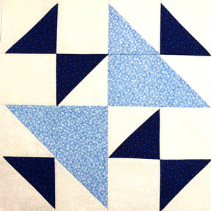 Triangle Weave Quilt Block with light blue and dark blue triangles in a white background