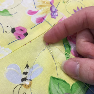 Hand quilting on a butterfly quilt