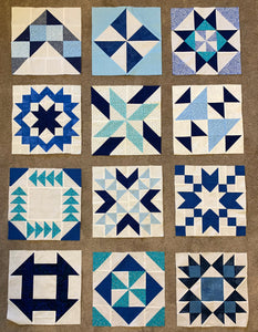 Quilt blocks laid out with spaces for sashing