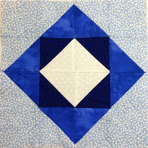 The Shadow Box Quilt Block made with a variety of blues and white