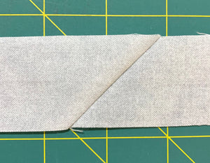 Two strips of fabric sewn together on the diagonal