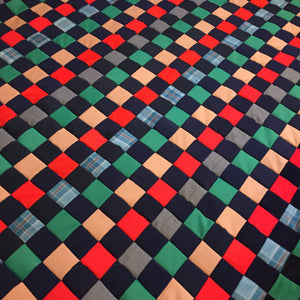 Polyester Quilt with squares and stripes of colors.