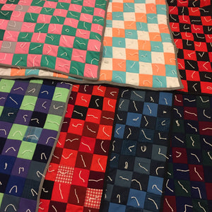 Seven polyester throw quilts made from polyester pants with lots of squares