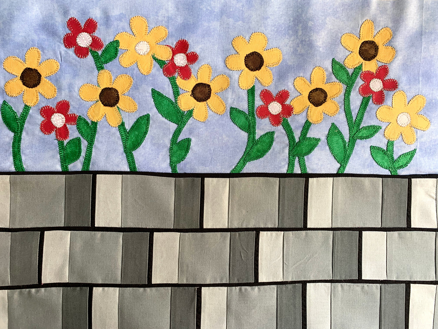Sunflowers on a brick wall quilt row or quilt block