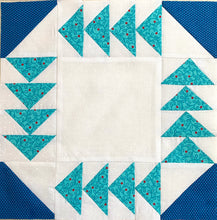 Fox and Geese Quilt Block. Teal flying geese around the edges with a medium blue corner half square triangles on a white background
