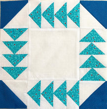 Fox and Geese Quilt Block. Teal flying geese around the edges with a medium blue corner half square triangles on a white background