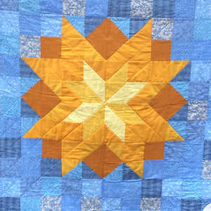 Close up of the sun center of the You Are My Sunshine Quilt.