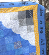 Close up the corner of the You Are My Sunshine quilt - looking at the clouds, borders, and wording.