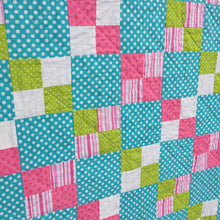 Close up of Alana Quilt Pattern - Easy quilt made in squares with pink, teal, white, and green