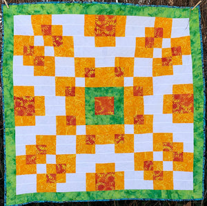 Counterbalance Quilt  made in Orange, Yellow, Green, and White. Beginner quilt, made with squares.