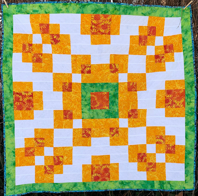 Counterbalance Quilt  made in Orange, Yellow, Green, and White. Beginner quilt, made with squares.
