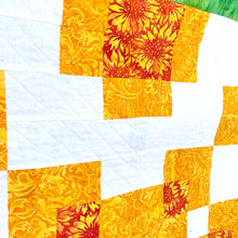 Counterbalance Quilt  made in Orange, Yellow, Green, and White. Beginner quilt, made with squares.