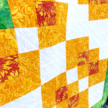 Counterbalance Quilt  made in Orange, Yellow, Green, and White. Beginner quilt, made with squares.