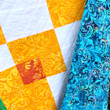 Counterbalance Quilt  made in Orange, Yellow, Green, and White. Beginner quilt, made with squares.